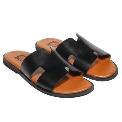 Black handcrafted leather slippers with tan footbed and minimal design, featuring leather sole by Shoe Bespoke.